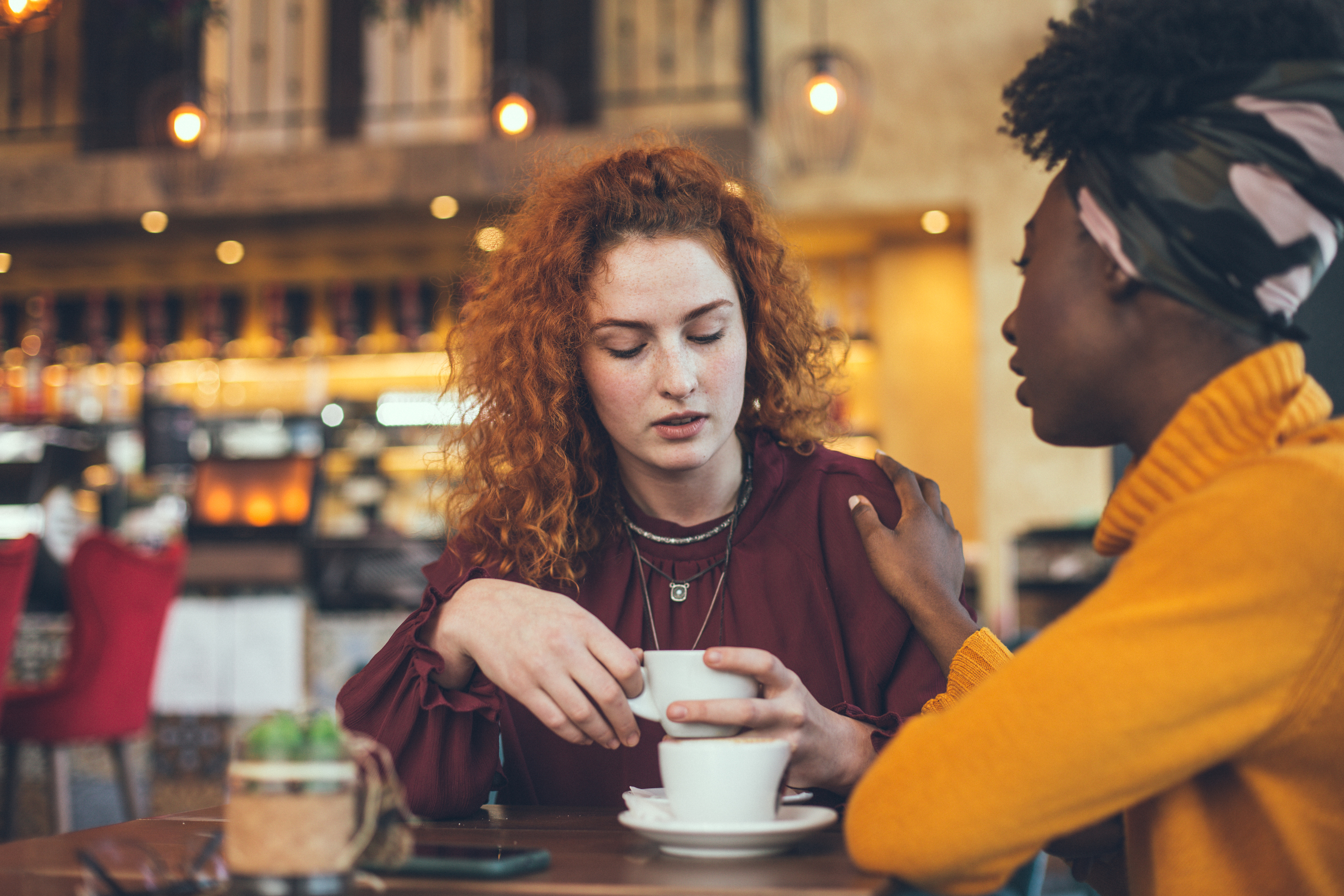 Two women having a conversation in a coffee shop