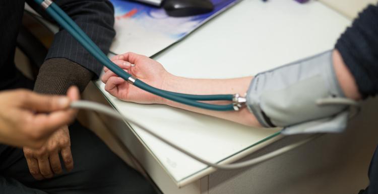 Patient having their blood pressure taken by their GP