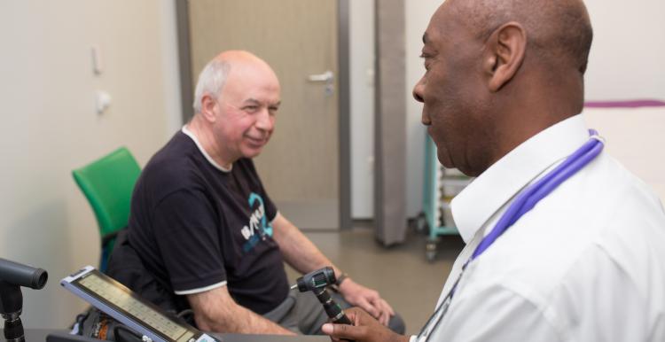 Man sitting in consulting room talking to his GP