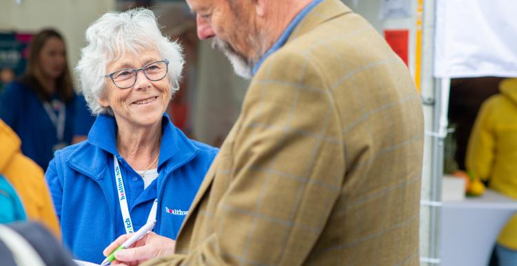 Healthwatch volunteer talking to a man