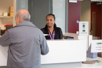 Receptionist talking to a member of the public