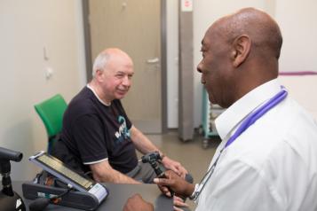 Man sitting in consulting room talking to his GP