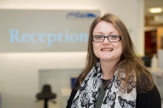 Women stood in front of a reception sign