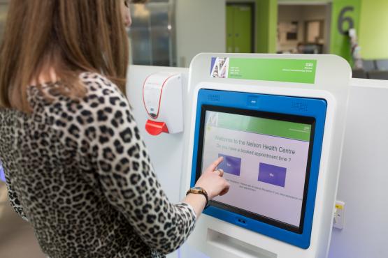 woman at touch screen at gp service woman at touch screen at gp service