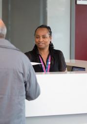 Receptionist talking to a member of the public 